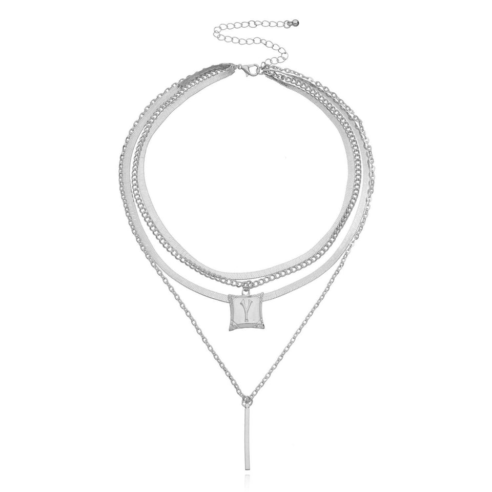 Lagerhalsband i guldfärg med mynt och berlocker