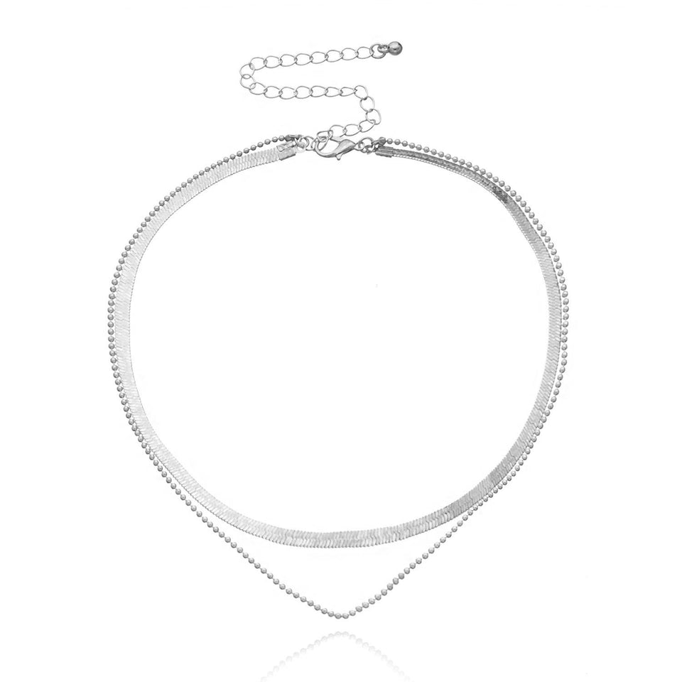 Lagerhalsband i guldfärg med mynt och berlocker