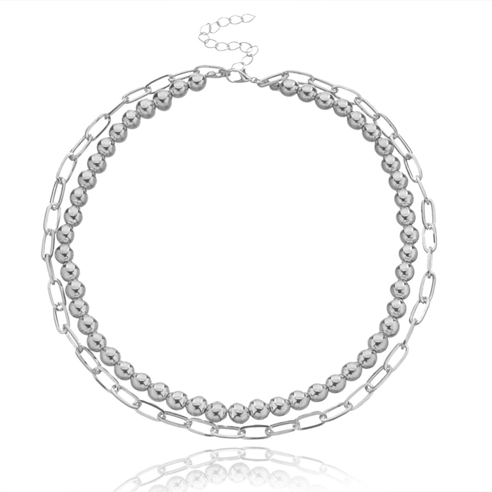 Lagerhalsband i guldfärg med mynt och berlocker