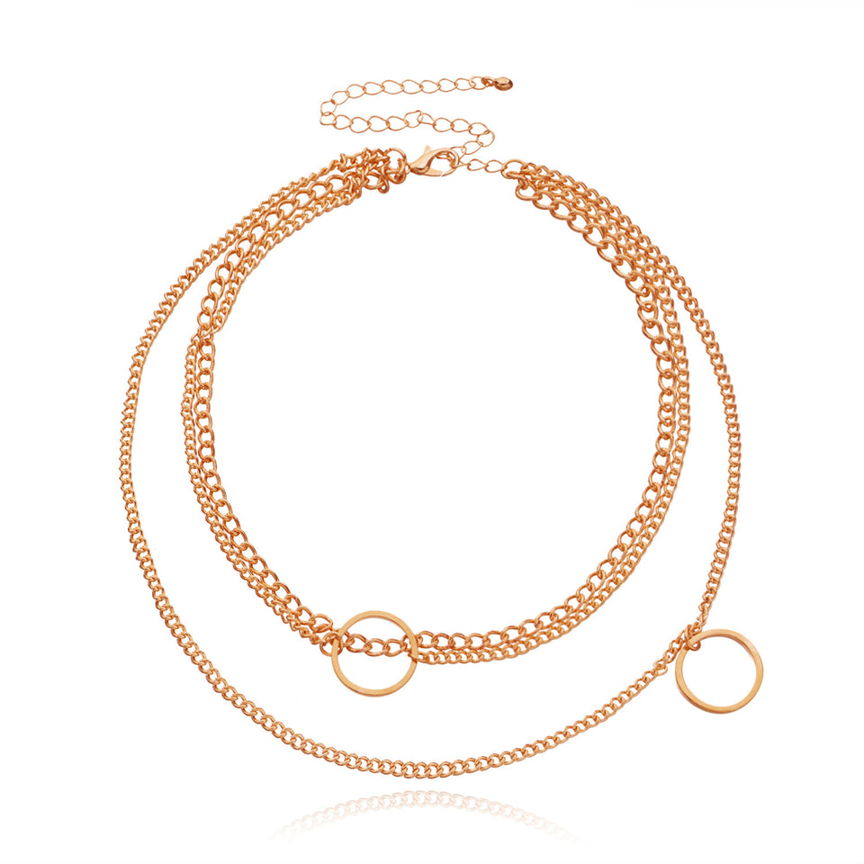 Lagerhalsband i guldfärg med mynt och berlocker