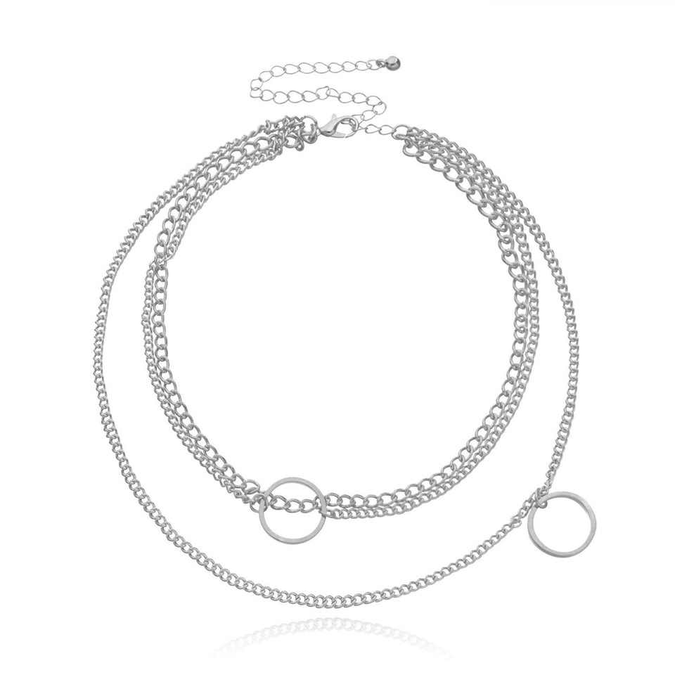 Lagerhalsband i guldfärg med mynt och berlocker