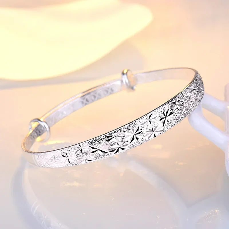 Silverfärgad armring med stjärnmönster